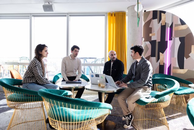 "In the strange red chair, it is our Finance Manager surrounded by her accomplices." - Wojo
